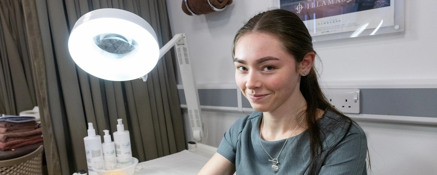 Beauty student smiles at the camera